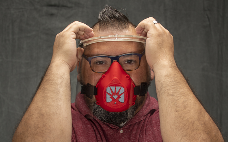 Juan Fernandez, ECC Art Gallery Curator, with an ECC-branded PPE mask